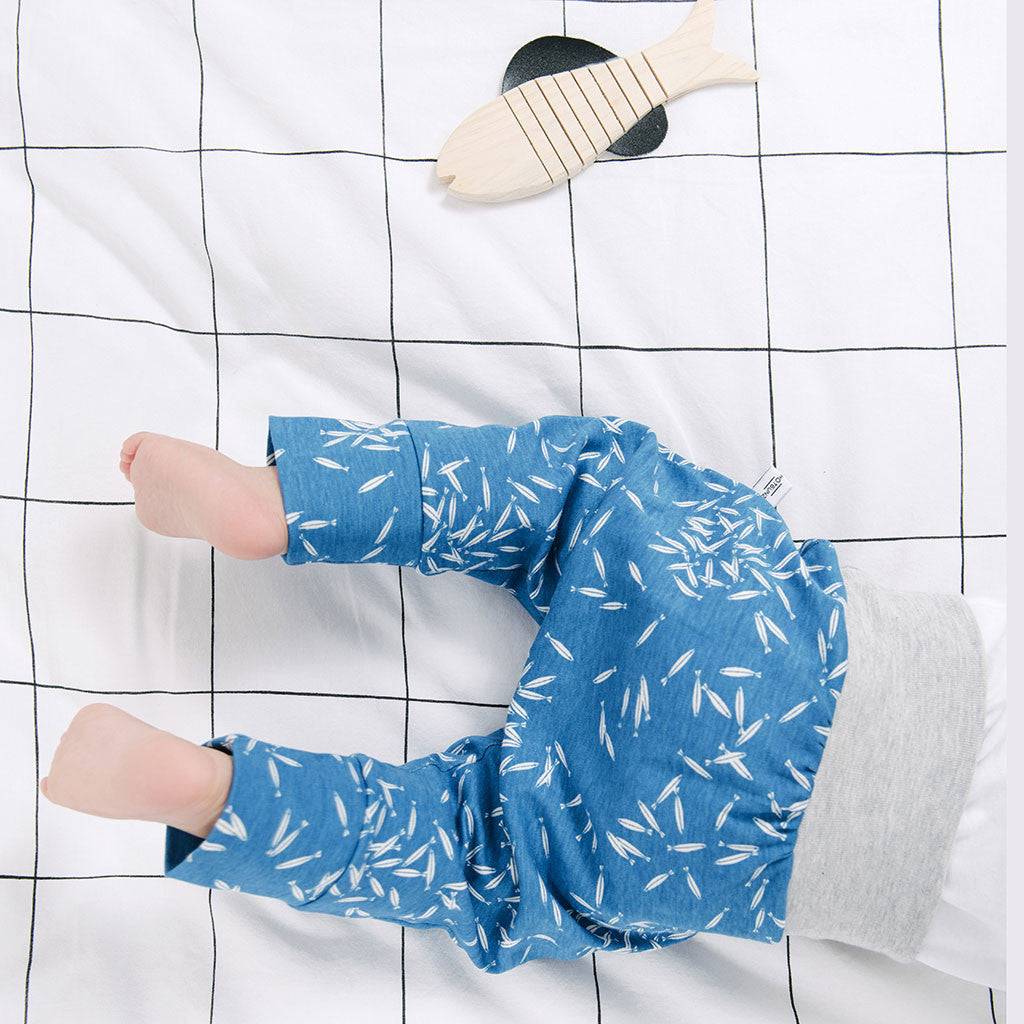 baby legs in blue pants with fish prints