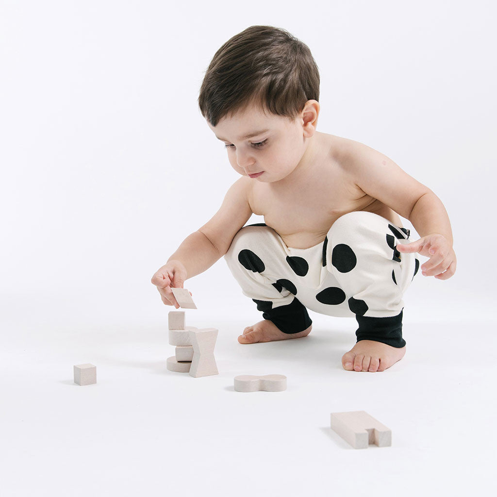 baby in white and black polka dots pants 