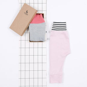 flatlay of pink baby pants gift set